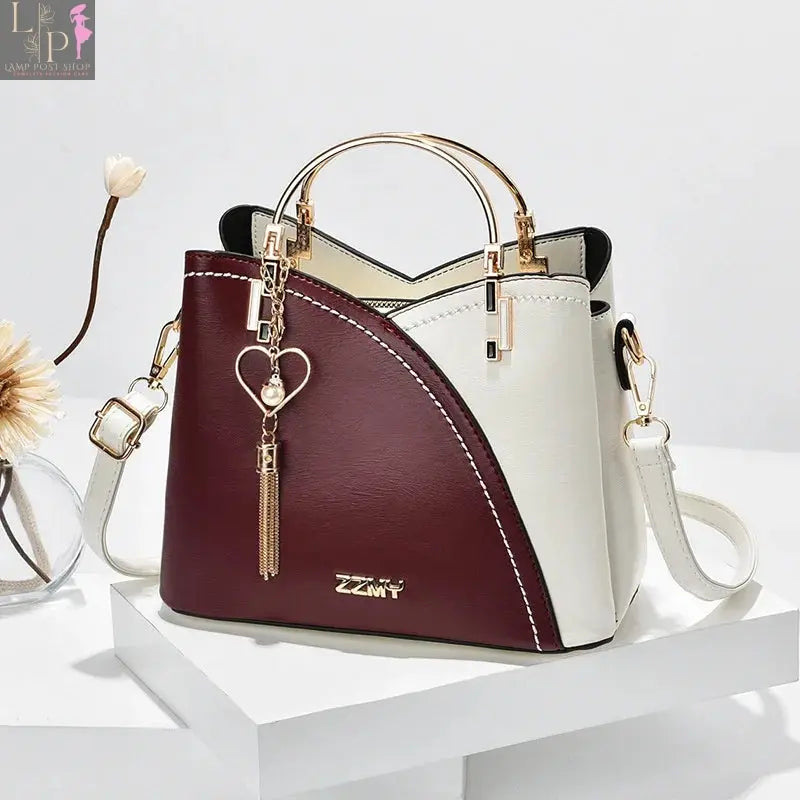 Wine-red women’s shoulder bag with white accents, stylish and spacious bag designed for everyday use.