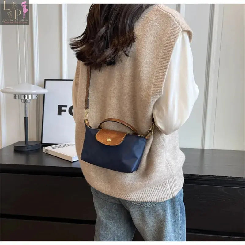 Black women and girls crossbody bag for 2024, stylish and compact, with adjustable strap and minimalist design.