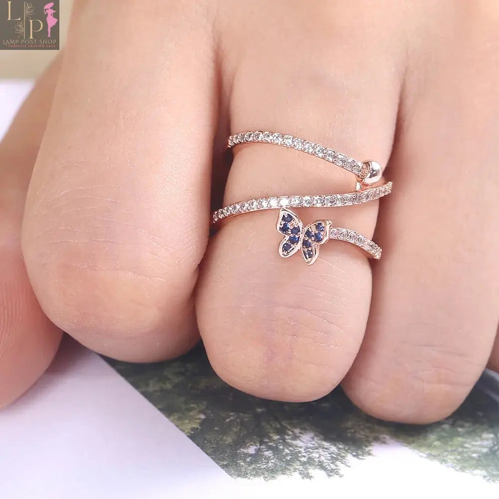 Rose gold butterfly-shaped ring with detailed butterfly designs, showcasing an elegant jewelry piece from My Store.