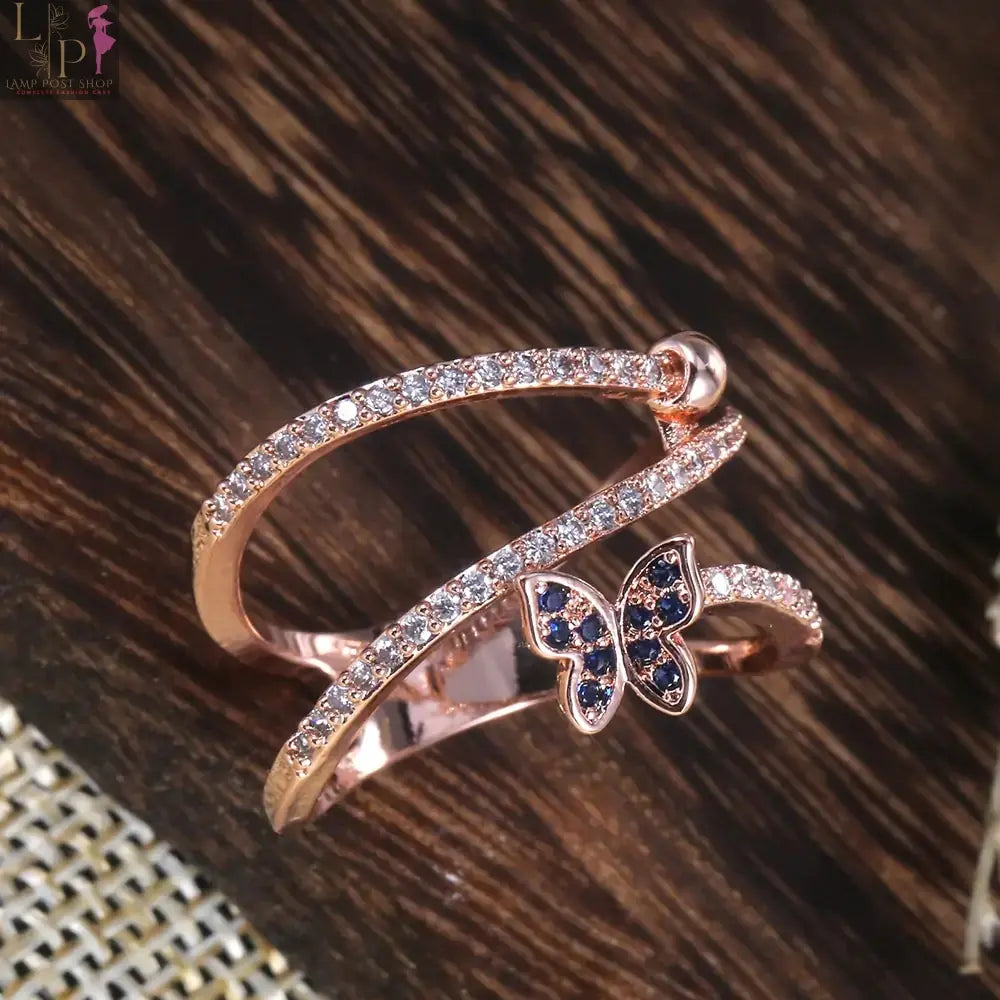 Rose gold butterfly-shaped ring featuring delicate butterfly designs, ideal for elegant jewelry collection.