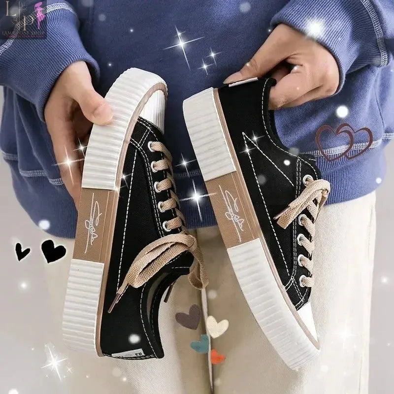 White low-top canvas women's sneakers with lace-up design, breathable casual shoes with flat soles and vulcanized rubber bottoms.