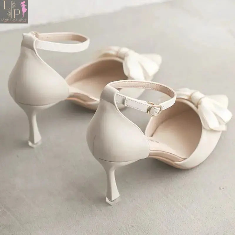 White women's high heels with elegant design, suitable for weddings, bridal parties, and formal occasions.