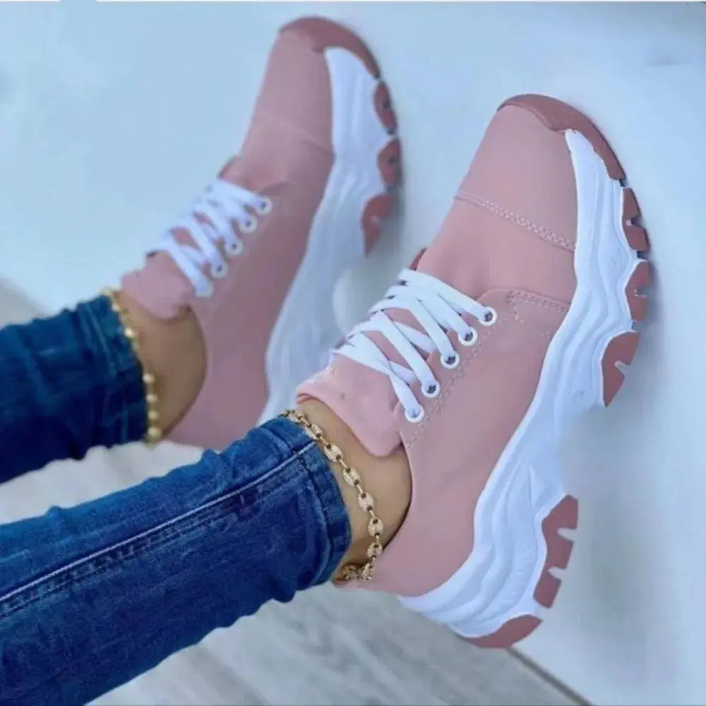 Pink women's canvas sneakers with flat laces, casual sport shoes for women, stylish and comfortable for everyday wear.