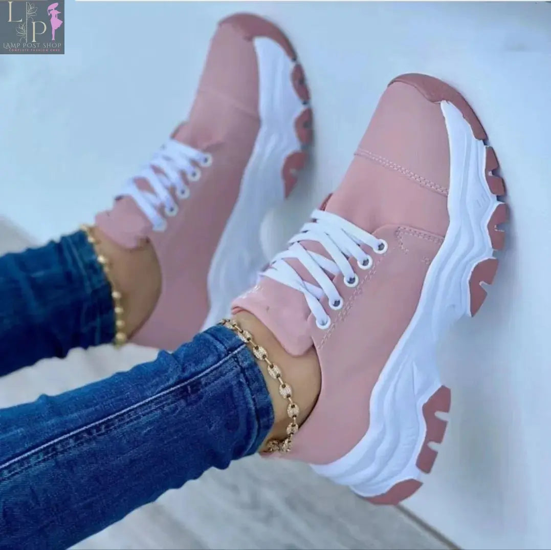 Pink women's canvas sneakers with flat laces, casual sport shoes for adults, featuring comfortable design and stylish look.