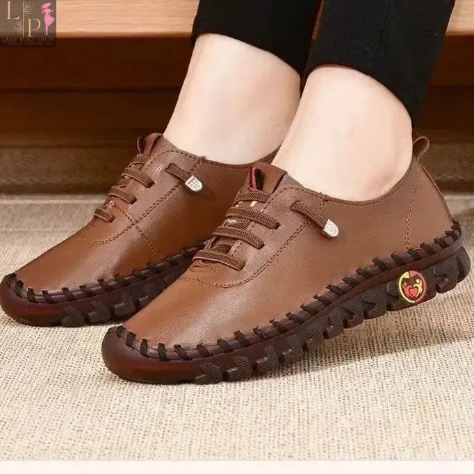 White women's summer flat shoes, orthopedic loafers and moccasins with stitched slip-on design, perfect for casual wear.