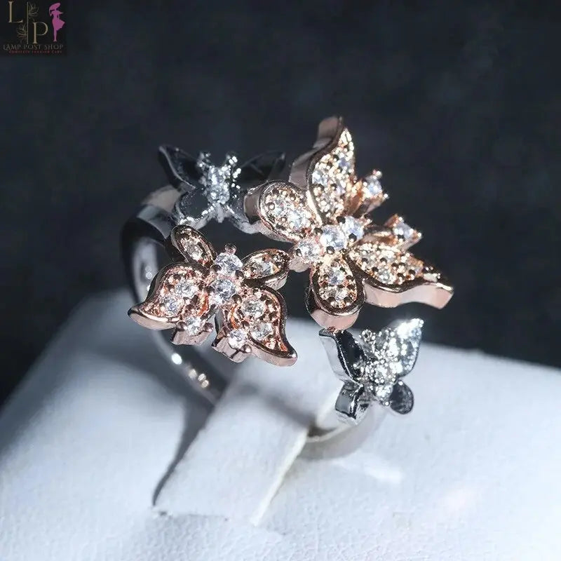 White butterfly engagement ring with delicate details, featuring a silver band and butterfly motif for romantic elegance.
